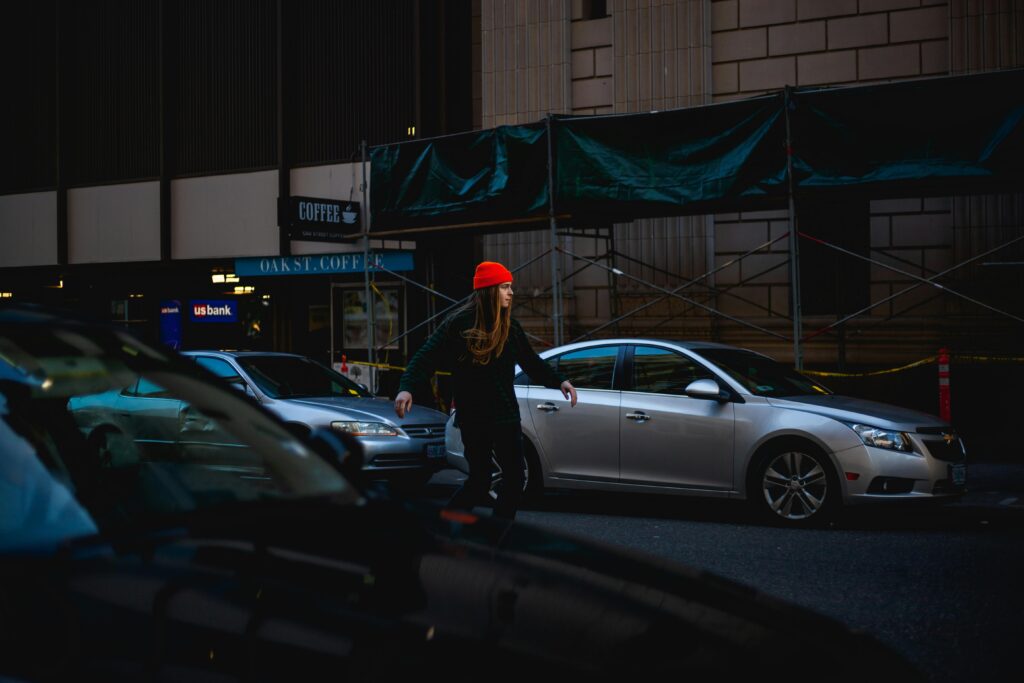 pexels-photo-2463271-2463271 Woman in red hat crossing city street surrounded by cars at daytime.